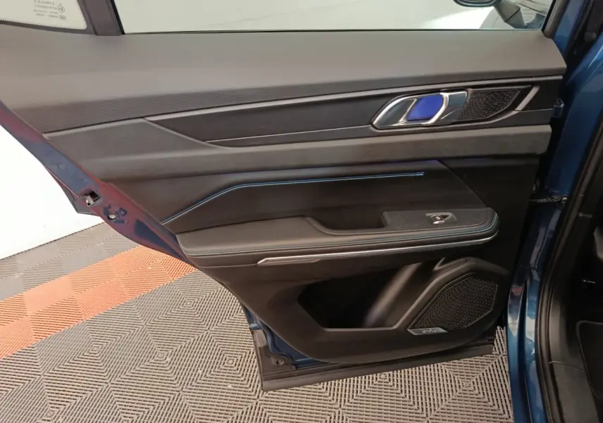 Vue intérieure côté gauche de la porte arrière bleu du Link & Co 01 avec garniture noire et surpiqûres bleues.