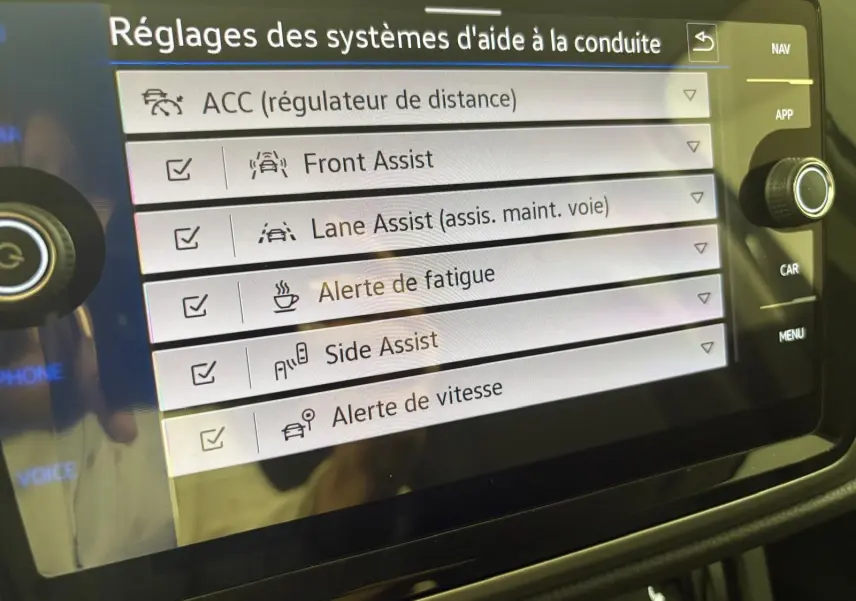 Écran tactile intérieur affichant les réglages des aides à la conduite du Volkswagen Touran 2025 en gris dauphin.