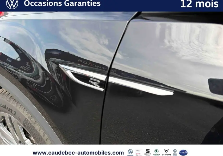 Gros plan sur l'aile arrière gauche noire du Volkswagen T-Roc Cabriolet avec logo R et jante visible.