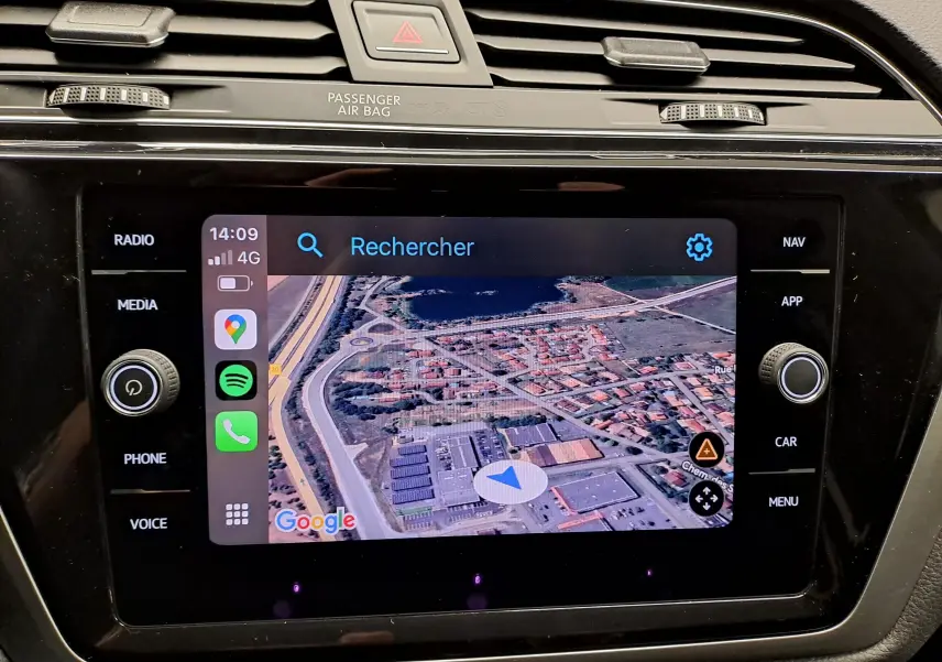 Écran tactile central du Volkswagen Touran 2025 affichant la navigation Google Maps avec commandes autour en finition noire brillante.