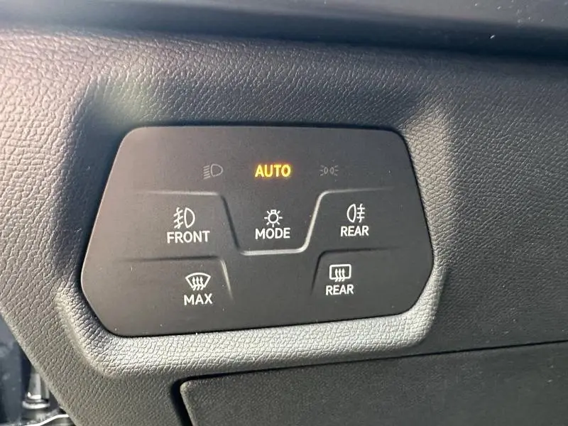 Gros plan sur les commandes d’éclairage et de dégivrage du tableau de bord du CUPRA Formentor gris Graphène.