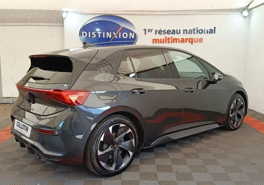 Vue 3/4 arrière droit d'une CUPRA BORN gris foncé électrique avec jantes noires et feux arrière LED distinctifs.