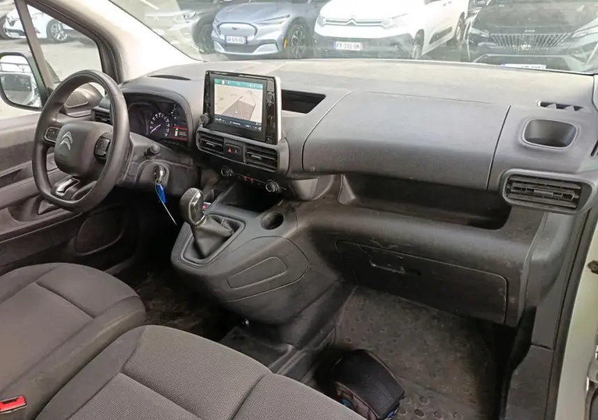 Vue intérieure côté conducteur du Citroën Berlingo blanc 2020, tableau de bord avec écran tactile et boîte manuelle.