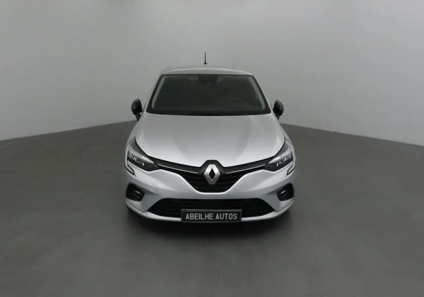 Renault Clio V gris platine vue de face, mettant en valeur la calandre noire et les phares LED modernes.