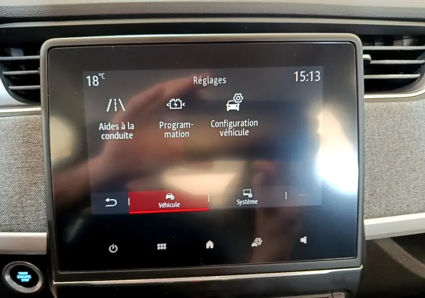 Écran tactile central de la Renault ZOE blanc, affichant les réglages du véhicule en intérieur.
