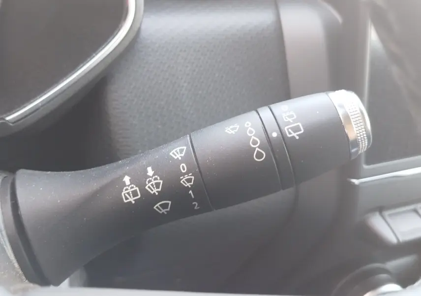 Gros plan sur la commande des essuie-glaces dans l’habitacle d’une Renault Clio blanche Business 2021, version essence.
