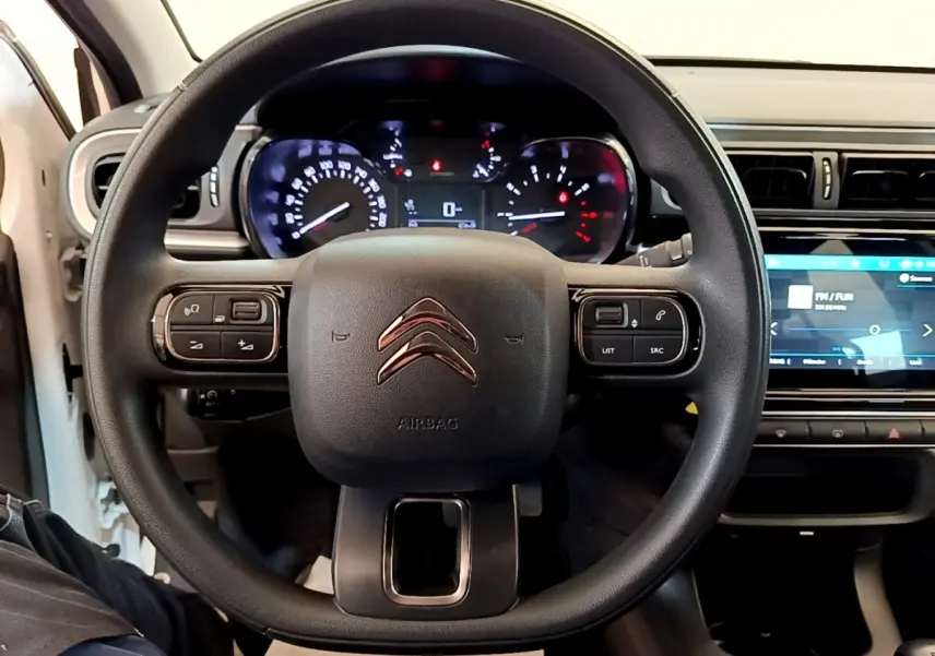 Vue intérieure centrée sur le volant multifonctions noir de la Citroën C3 2022 avec tableau de bord et écran tactile visibles.
