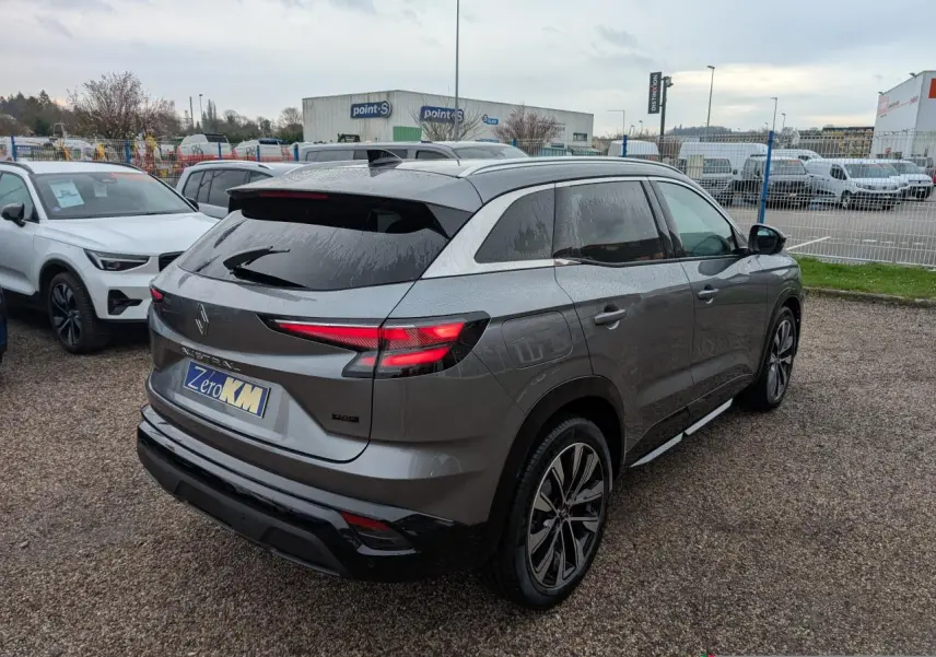 Vue 3/4 arrière droite d'un Renault Austral gris avec jantes alliage noires et vitres arrière surteintées.