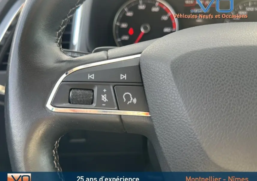 Gros plan sur les commandes vocales et volume du volant cuir du SEAT Ateca bleu foncé 2019.