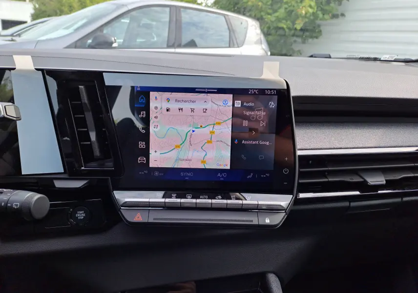 Tableau de bord du Renault Austral 2025 avec écran tactile central affichant navigation et commandes climatiques.