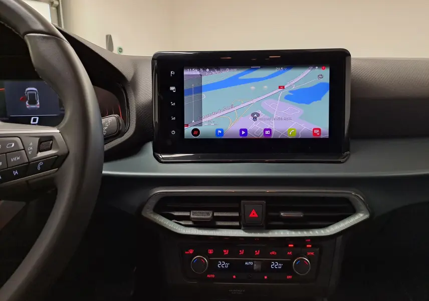 Vue intérieure centrée sur l'écran tactile du tableau de bord du SEAT Arona 2024 avec navigation affichée.