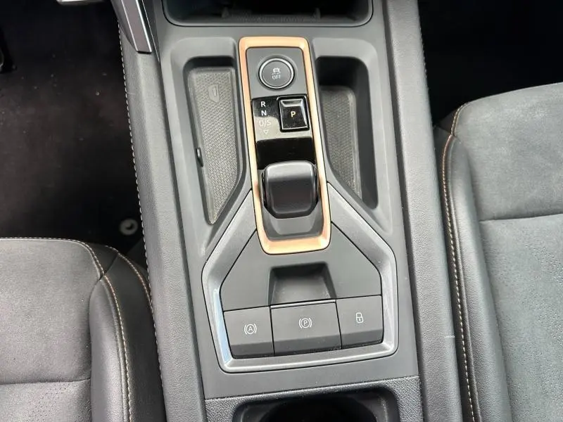 Vue plongeante sur la console centrale noire du CUPRA Formentor avec levier de vitesse électronique et surpiqûres marron.