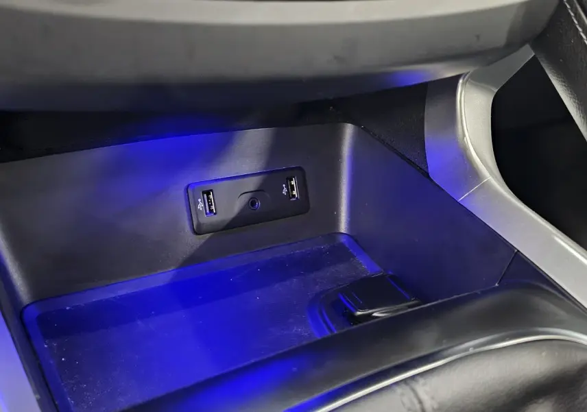 Gros plan sur la console centrale du Renault Kadjar 2021, avec éclairage bleu et ports USB visibles.