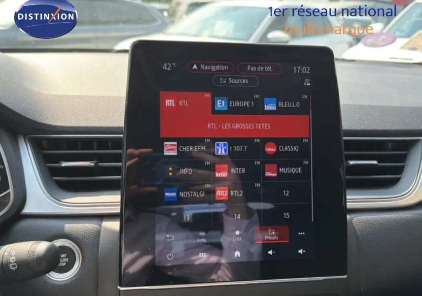 Vue intérieure du tableau de bord du Renault Captur 2022, écran tactile central affichant les stations radio.