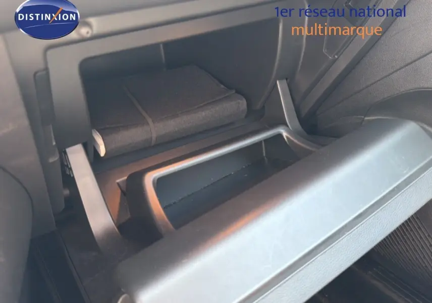 Coffre à gants ouvert du Renault Captur 2022 bleu marine fumé, montrant un carnet de bord à l'intérieur.