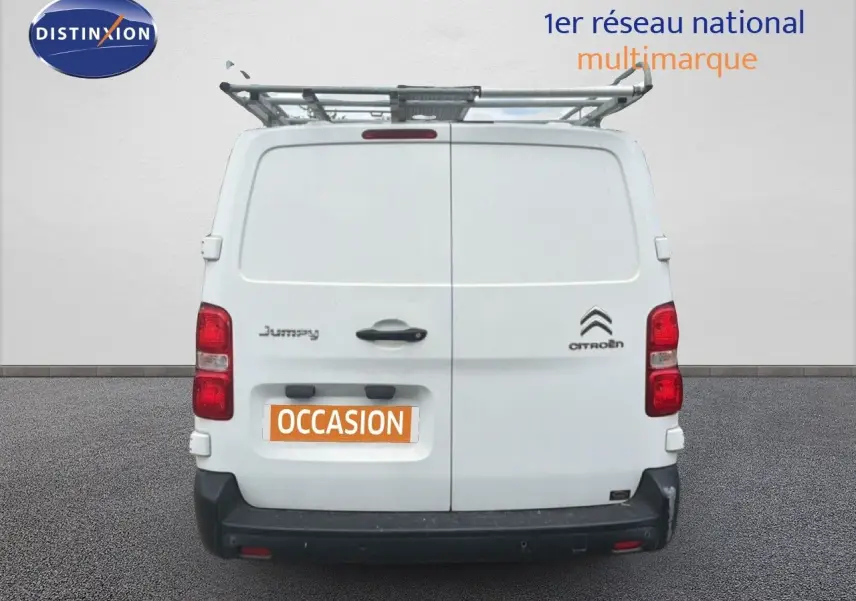 Vue arrière d’un utilitaire Citroën Jumpy blanc avec galerie de toit et plaque « OCCASION » visible.