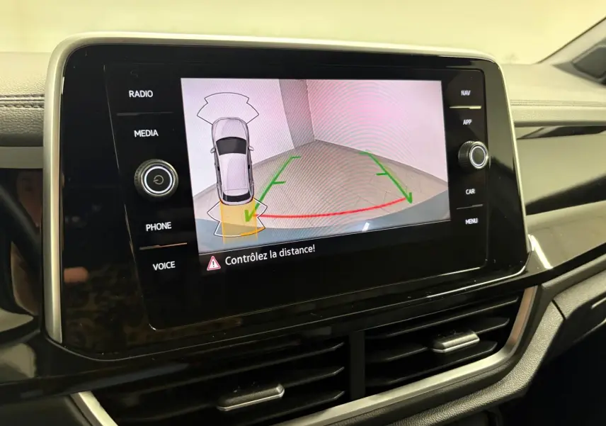 Écran central du Volkswagen T-Roc 2024 affichant la caméra de recul avec alertes de distance.