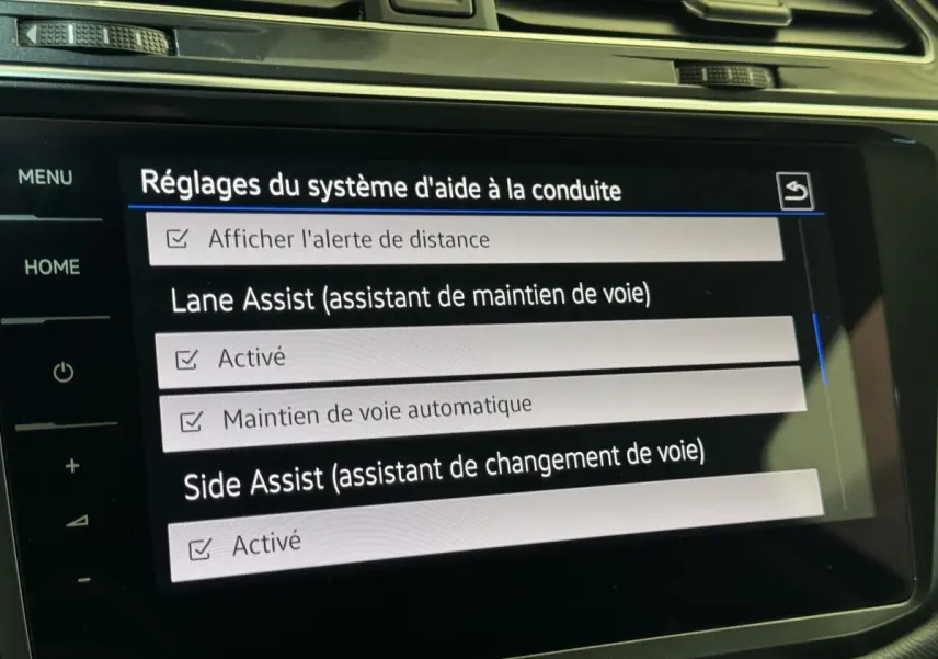 Écran tactile intérieur du Volkswagen Tiguan Allspace affichant les réglages d’aide à la conduite.