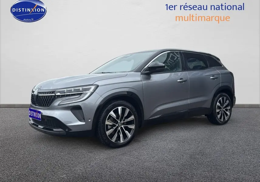 Renault Austral gris schiste en 3/4 avant droit, avec jantes alliage et toit noir contrasté visible.