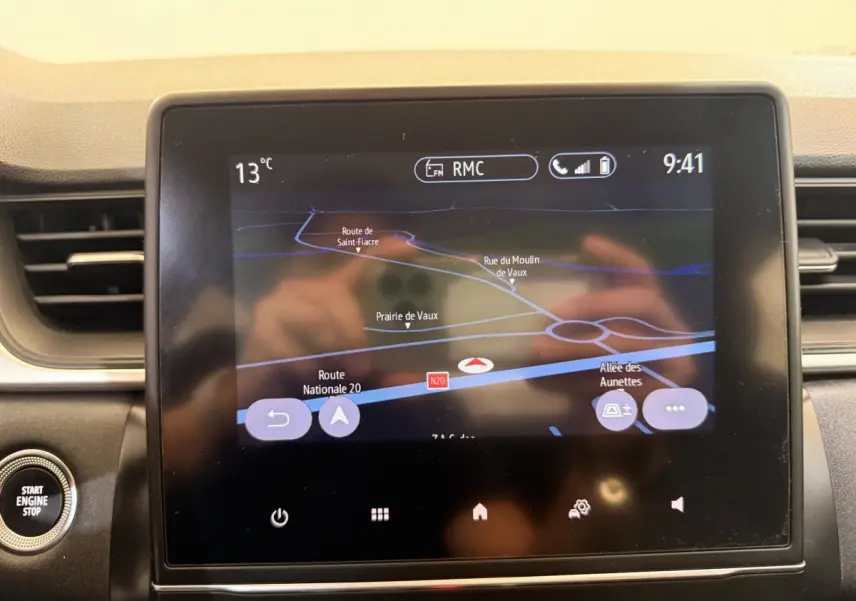 Écran tactile central du tableau de bord du Renault Captur blanc, affichant la navigation GPS en intérieur.