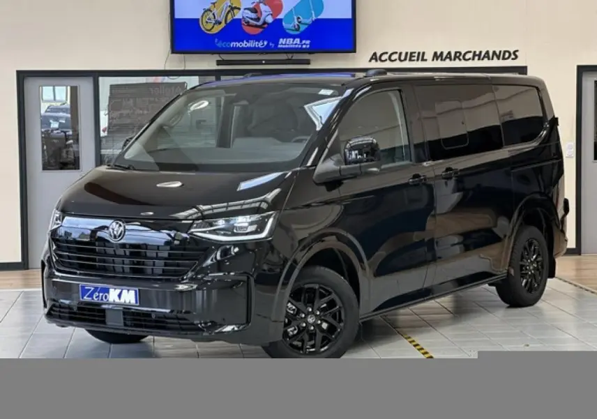 Vue 3/4 avant du Volkswagen Transporter T7 ProCab noir minuit avec jantes alliage noir brillant en showroom.