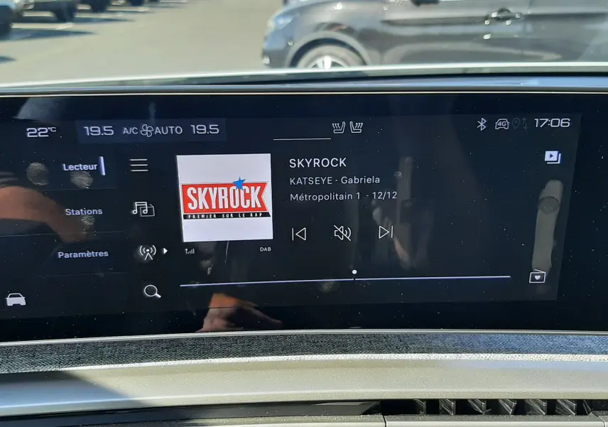 Écran tactile central du Peugeot 3008 Hybrid 2024 affichant la radio Skyrock, avec commandes et tableau de bord visibles.