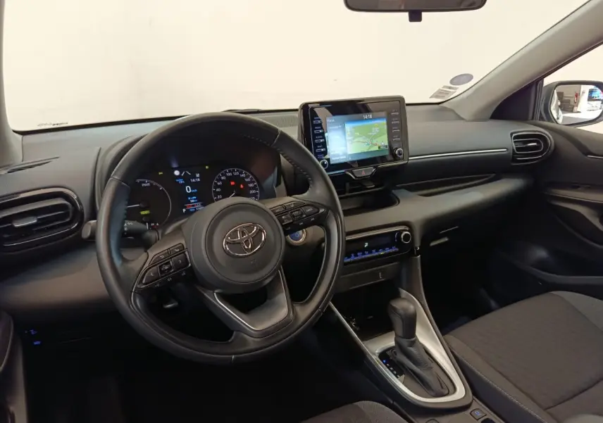 Intérieur de la Toyota Yaris Hybride 116h 2022 vu côté conducteur, volant cuir multifonctions et écran tactile central.