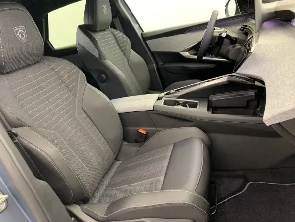 Intérieur avant droit du Peugeot 3008 1.2 Hybrid 145 GT, sièges cuir gris avec surpiqûres et console centrale ouverte.