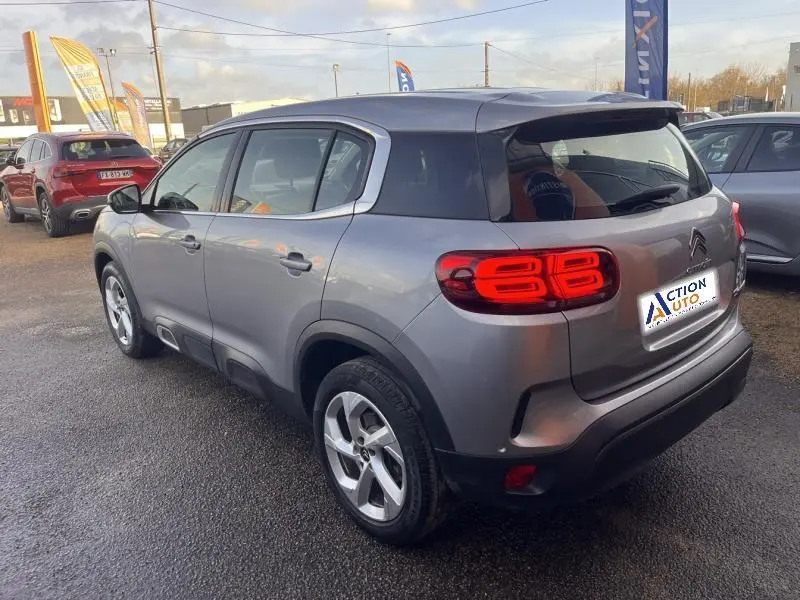 Citroën C5 Aircross gris Platinium vue 3/4 arrière droit avec feux arrière LED distinctifs allumés.
