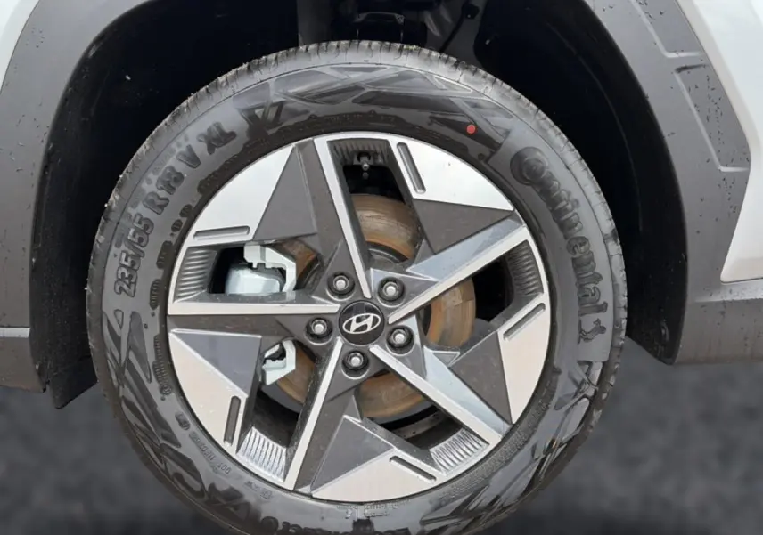 Gros plan sur la jante alu 18 pouces gris et noir du Hyundai Tucson 2026, avec logo Hyundai visible au centre.