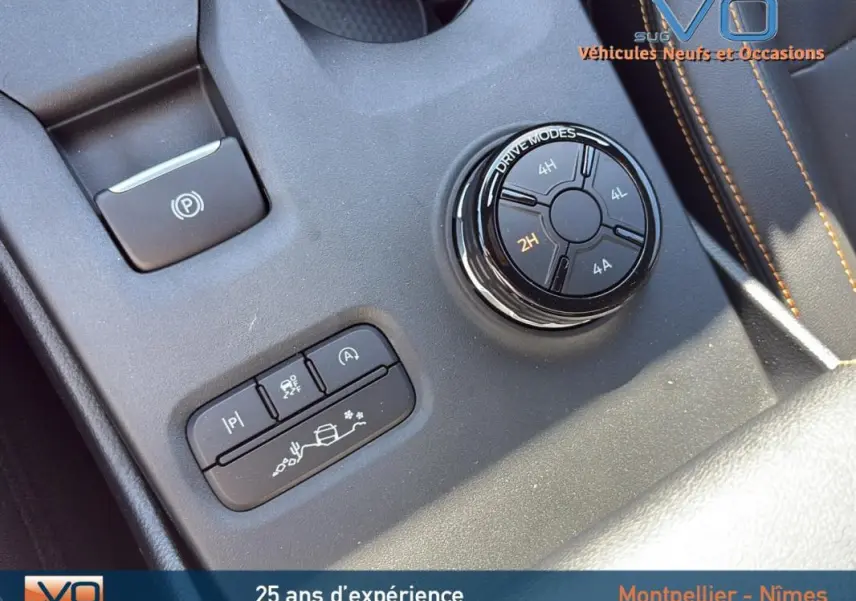Gros plan sur la console centrale du Ford Ranger noir 2025, montrant le sélecteur de modes de conduite et les commandes électroniques.