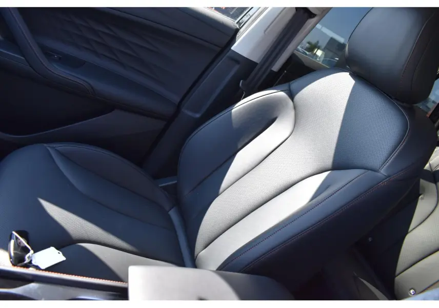 Gros plan sur le siège conducteur en similicuir noir avec surpiqûres marron du MG Motor EHS 1.5 Hybrid+ Luxury 2026.