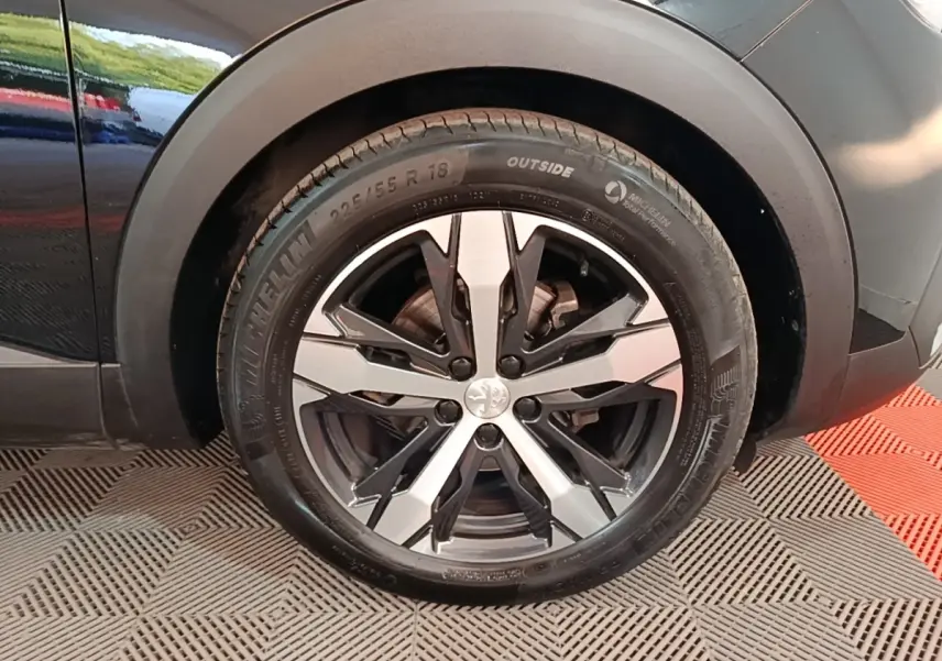 Gros plan sur la roue arrière droite noire du Peugeot 5008 avec jante alliage bicolore et pneu Michelin.