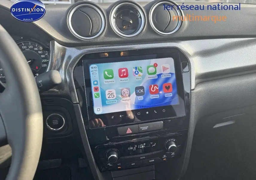 Vue intérieure centrée sur la console centrale noire du Suzuki Vitara avec écran tactile et commandes climatisation visibles.