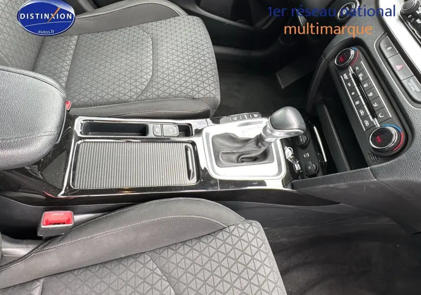 Vue intérieure centrée sur la console centrale et les sièges tissu noir de la Kia CEE'D SW 2020 avec boîte automatique.