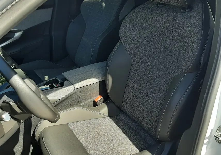 Vue intérieure côté conducteur du Peugeot 5008 Hybrid 145ch Allure 2025, sièges tissu gris et cuir noir.