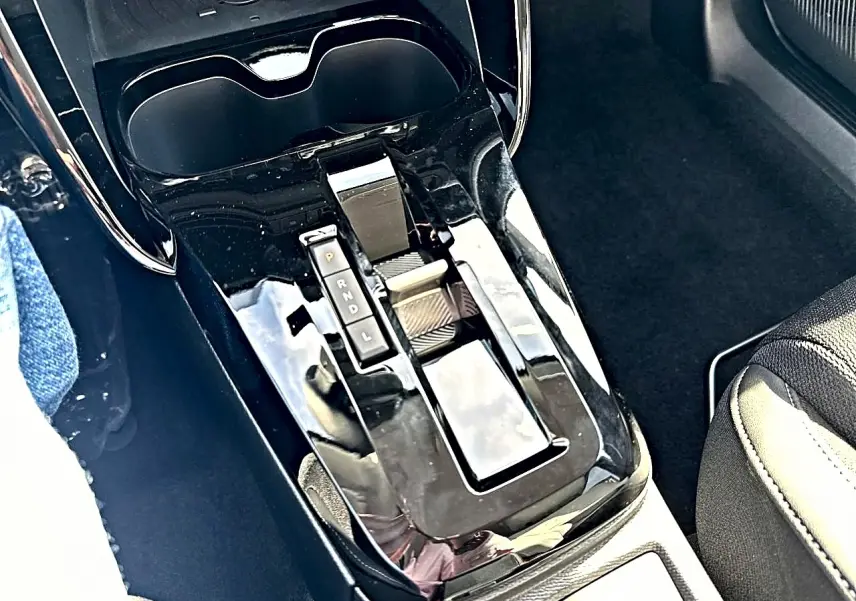 Vue rapprochée de la console centrale noire brillante avec levier de vitesses automatique dans un Citroën C3 Aircross.