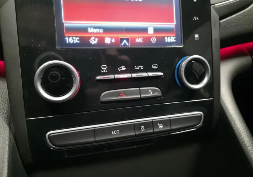 Gros plan sur la console centrale noire de la Renault Talisman Estate gris, avec commandes climatisation et écran tactile.