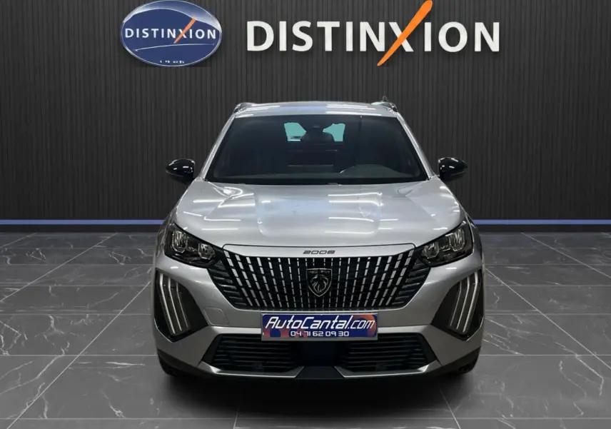 Peugeot 2008 gris Artense métal vue de face, soulignant la calandre verticale et les feux LED distinctifs.