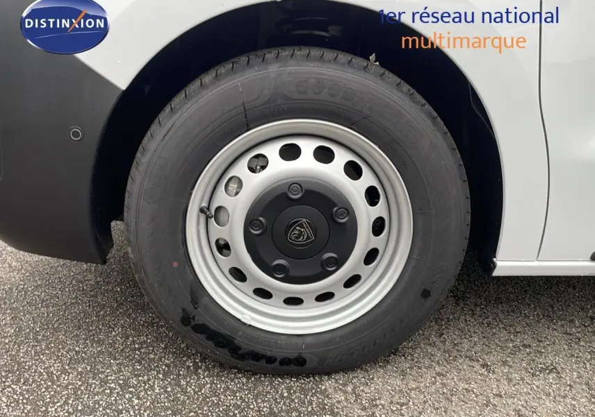 Gros plan sur la roue avant droite du Peugeot Expert Fourgon blanc Icy, soulignant la jante acier avec logo Peugeot central.