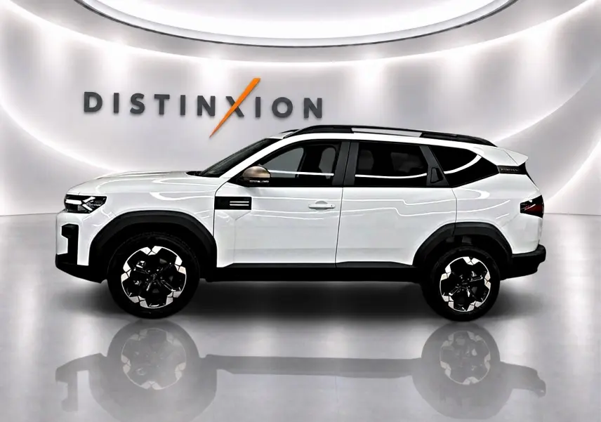 Profil droit du SUV blanc Dacia Bigster 2026 avec barres de toit noires et jantes alu distinctives.