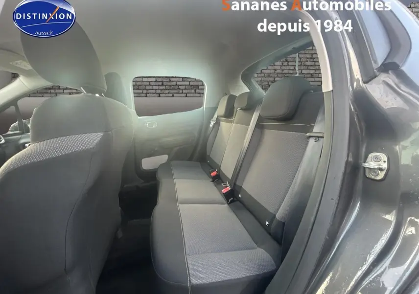 Vue intérieure côté droit des sièges arrière en tissu gris d'une Citroën C3 2023 gris foncé avec portières ouvertes.