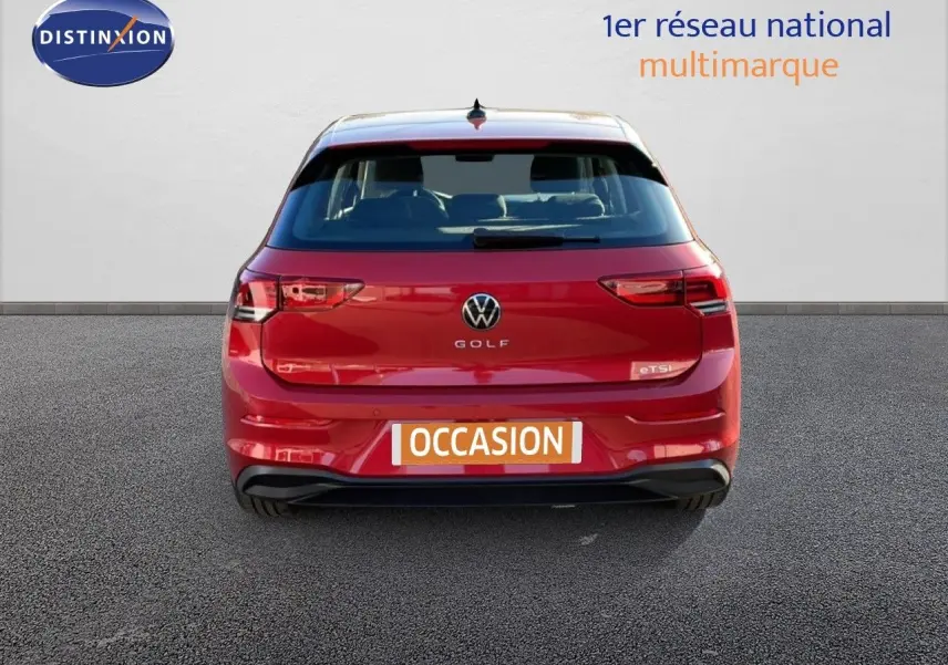 Vue arrière d'une Volkswagen Golf VIII rouge Roi Metal de 2023 avec logo et plaque occasion visible.