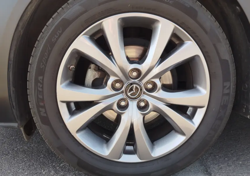 Gros plan sur la jante argentée en alliage du côté avant gauche du Mazda CX-30 noir de 2020.