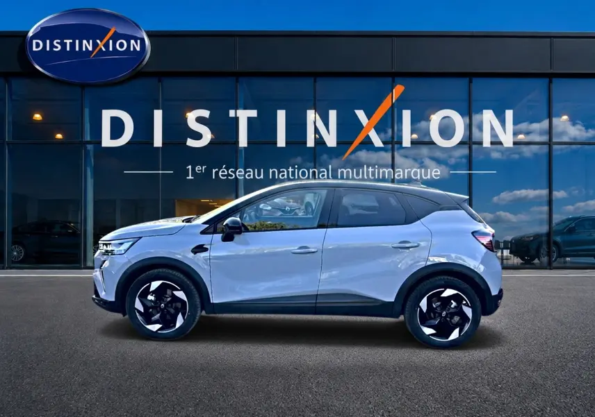Renault Captur 1.8 e-tech gris rafale en profil droit, jantes alu noires et toit noir contrasté.