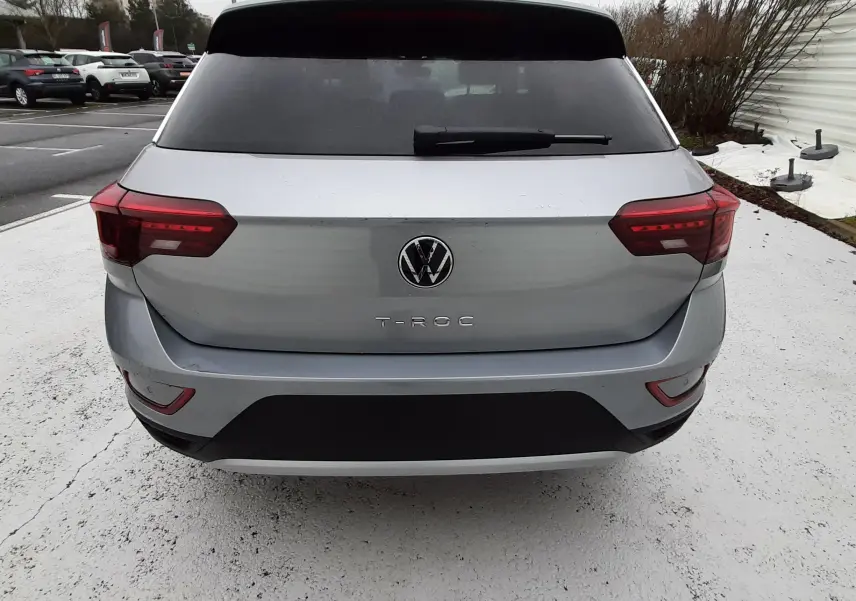 Vue arrière d'un Volkswagen T-Roc gris pyrite métal 2025 avec feux LED et lunette arrière teintée.
