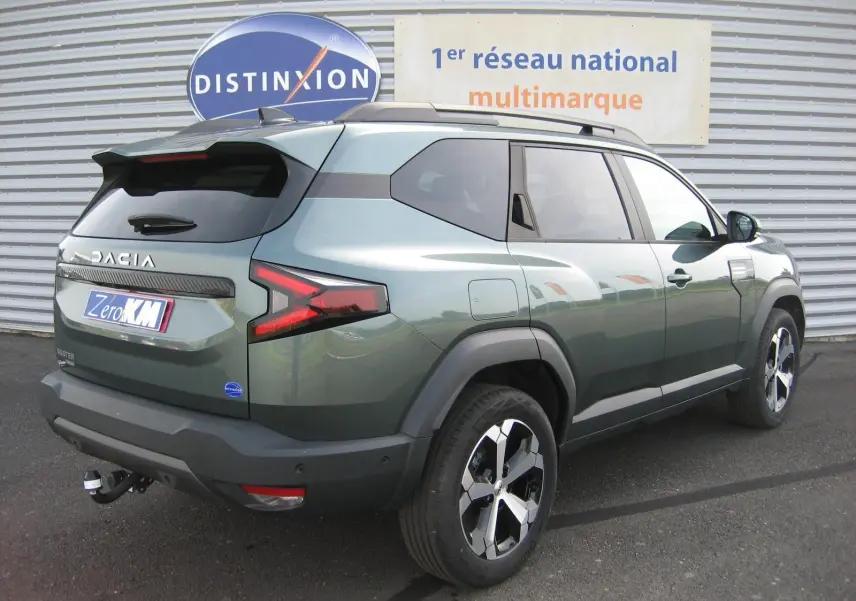Vue 3/4 arrière droite du Dacia Bigster gris schiste avec ses feux arrière en forme de Z et jantes noires et argentées.