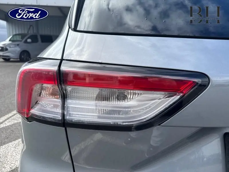 Gros plan sur le feu arrière droit d’un Ford Kuga gris Solar métallisé, soulignant ses lignes modernes et épurées.