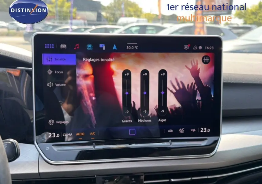 Vue intérieure centrée sur l'écran tactile du tableau de bord de la Volkswagen Golf SW 2026, avec réglages audio affichés.