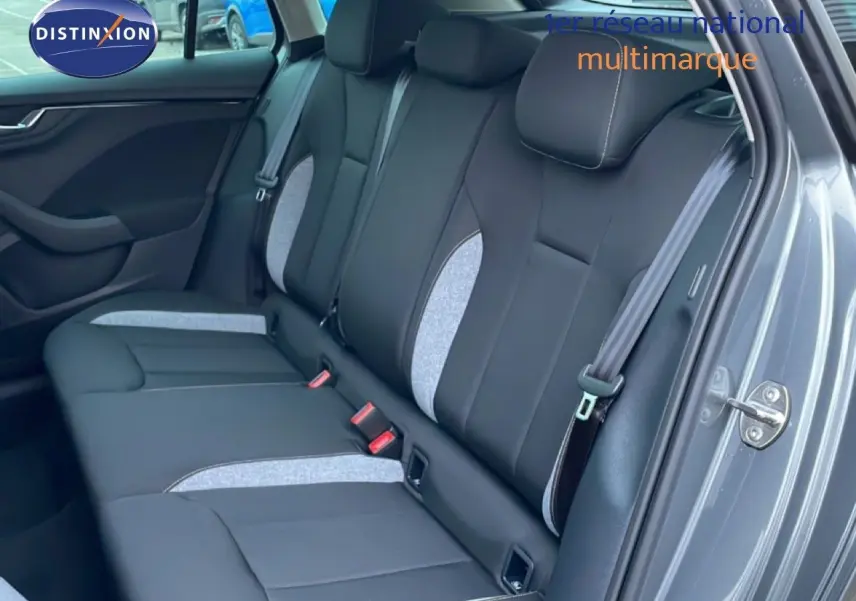 Vue intérieure côté droit montrant la banquette arrière en tissu noir et gris clair du Skoda Kamiq gris graphite 2025.